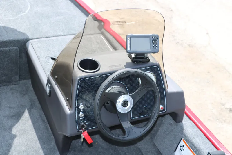 Slide: The Image of 2023 Bass Tracker Classix XL boat dashboard with steering wheel and navigation system. - 10