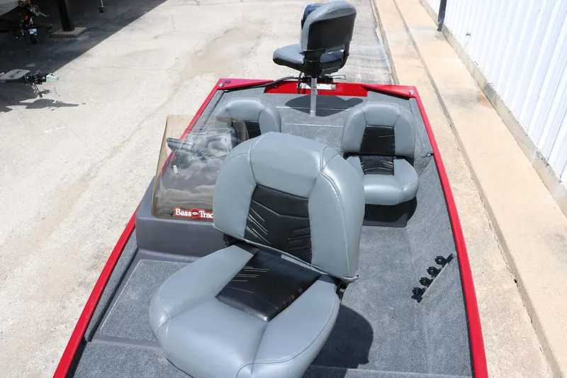 Slide: The Image of 2023 Bass Tracker Classix XL boat interior with gray seating and red trim. - 11