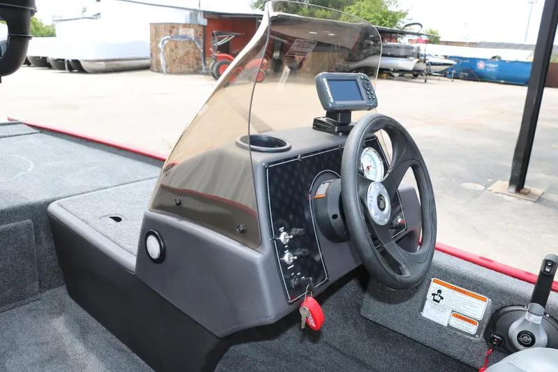 Slide: The Image of 2023 Bass Tracker Classix XL boat dashboard with steering wheel and navigation system. - 16
