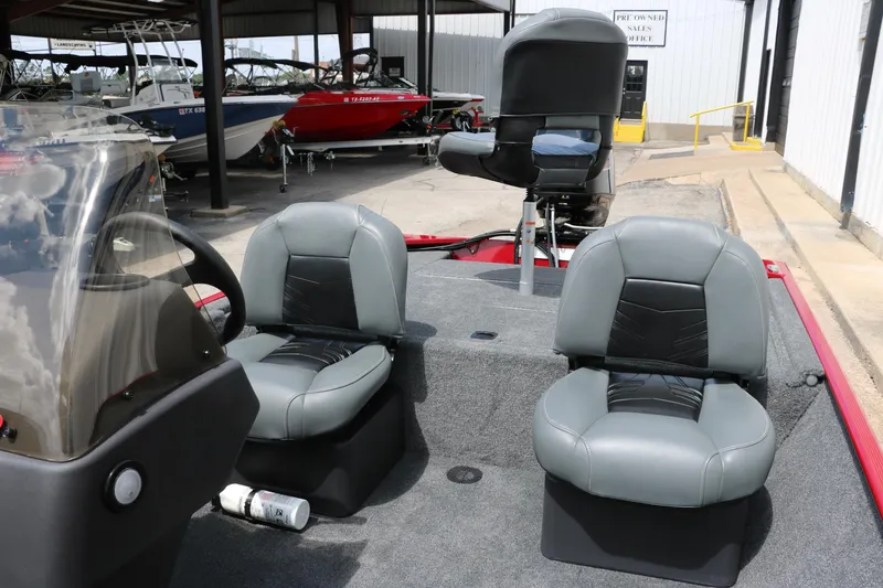 Slide: The Image of 2023 Bass Tracker Classix XL boat interior with gray seating and steering console. - 18