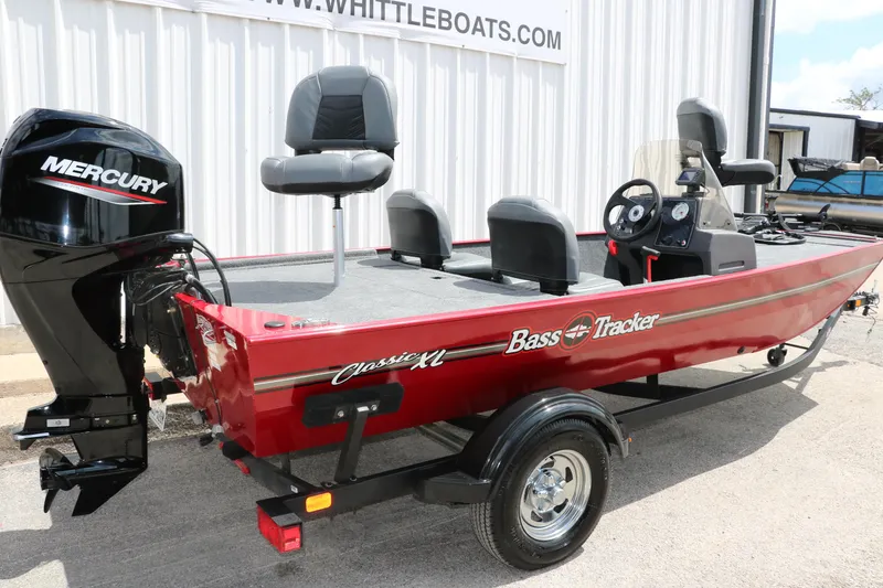 Slide: The Image of 2023 Bass Tracker Classix XL boat with Mercury engine, parked outside a dealership. - 3