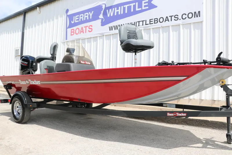 Slide: The Image of 2023 Bass Tracker Classix XL boat in red, displayed at Jerry Whittle Boats dealership. - 4