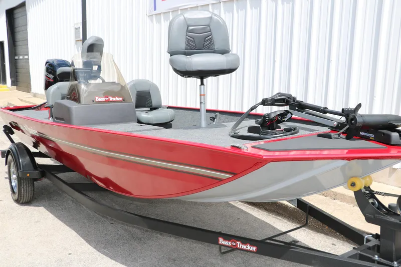 Slide: The Image of 2023 Bass Tracker Classix XL boat with red exterior and Minn Kota trolling motor. - 5