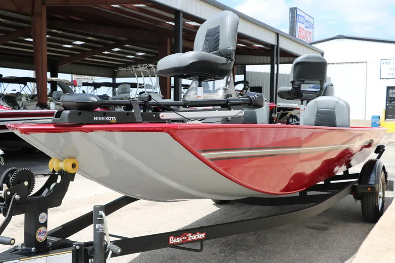 Slide: The Image of 2023 Bass Tracker Classix XL boat with Minn Kota motor, displayed outdoors. - 7