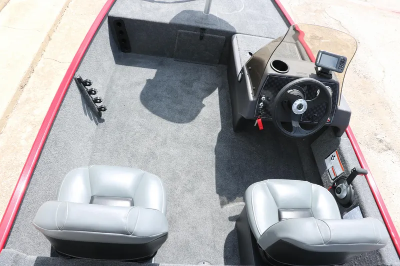 Slide: The Image of 2023 Bass Tracker Classix XL boat interior with steering console and seating. - 9