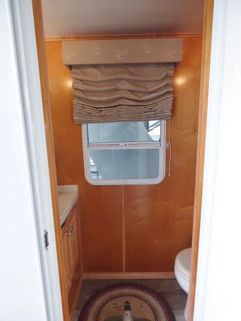 Slide: The Image of Compact bathroom with wooden walls, window, and decorative rug in a 2007 Fantasy model. - 20