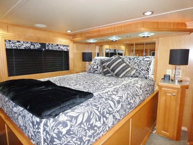 Slide: The Image of Luxurious bedroom with floral bedding in a 2007 Fantasy model 19x112 houseboat. - 7