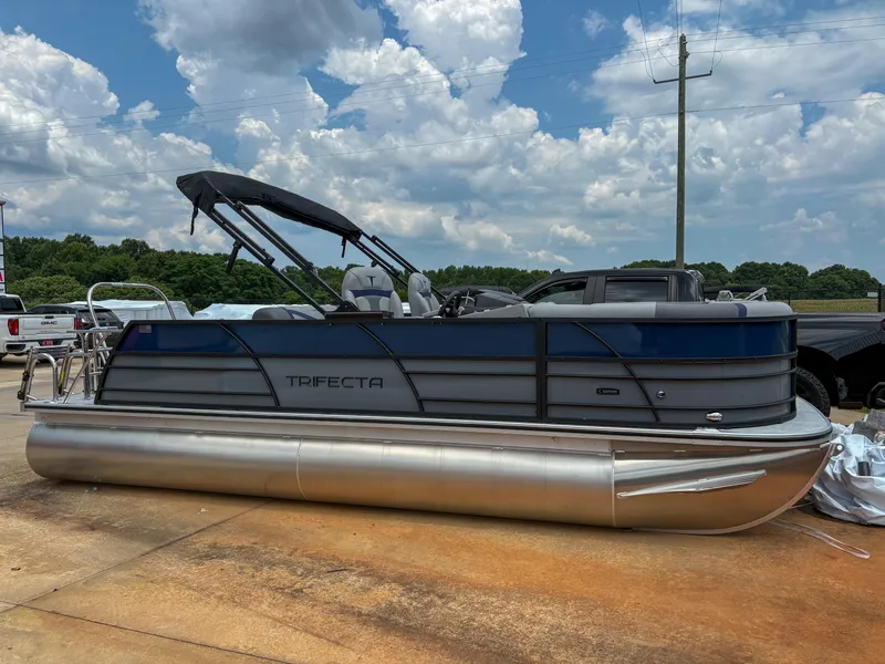 The Image of 2025 Trifecta CS 22UL 3.0 pontoon boat parked outdoors under a cloudy sky. - 0