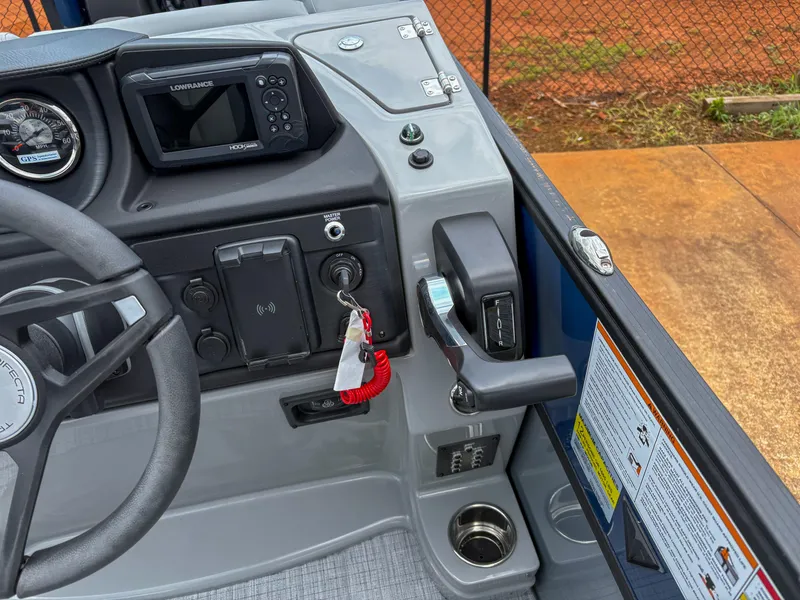 Slide: The Image of 2025 Trifecta CS 22UL 3.0 boat dashboard with steering wheel, controls, and navigation system. - 8