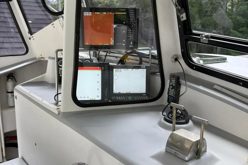 Slide: The Image of Boat cockpit with navigation equipment, Crowley-Beal 32, 1998 model, featuring control panel and screens. - 14