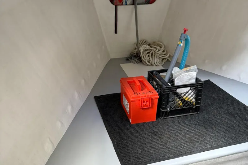 Slide: The Image of Interior of a 1998 Crowley-Beal 32 boat with storage items and equipment. - 24