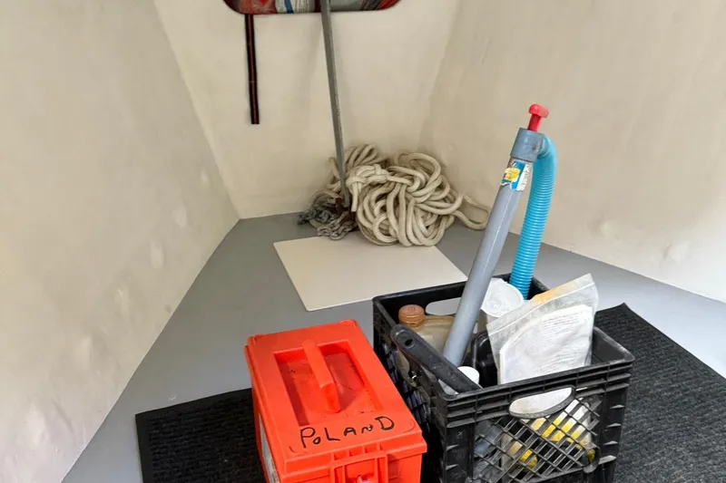 Slide: The Image of Interior of a 1998 Crowley-Beal 32 boat with storage items and coiled rope. - 25