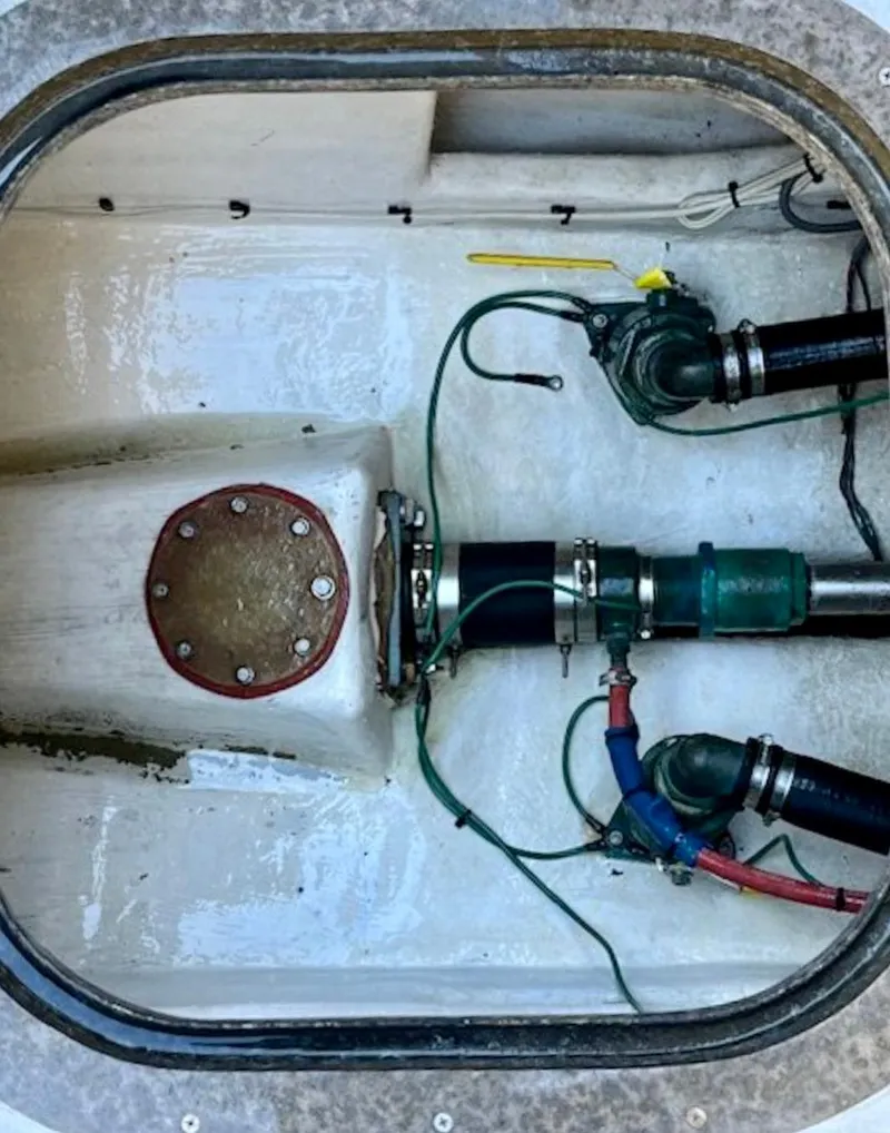 Slide: The Image of Engine compartment of a 1998 Crowley-Beal 32 boat, showing mechanical components and wiring. - 33