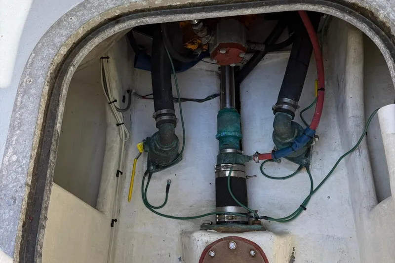 Slide: The Image of Engine compartment of a 1998 Crowley-Beal 32 boat, showing hoses and mechanical components. - 35