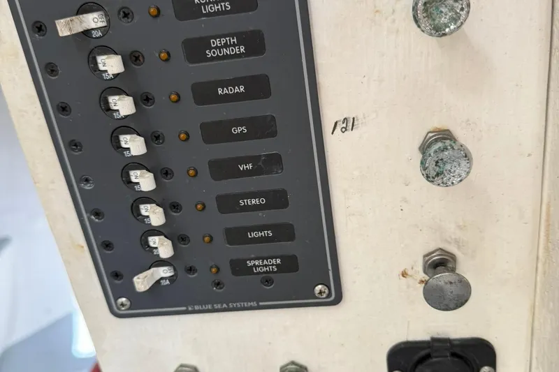 Slide: The Image of Control panel of a 1998 Crowley-Beal 32 boat with labeled switches and fuses. - 39