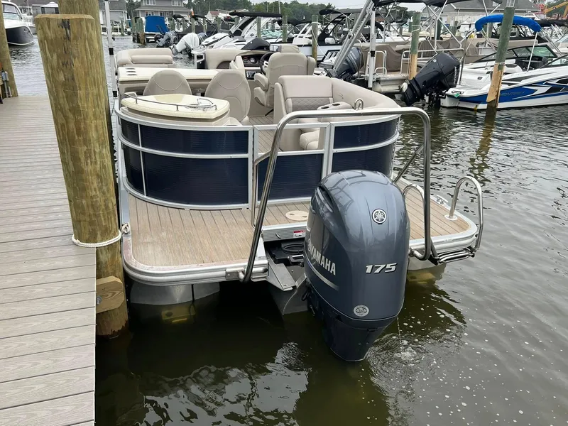 Slide: The Image of 2018 Bennington SX 23 pontoon boat docked with Yamaha 175 outboard motor. - 3