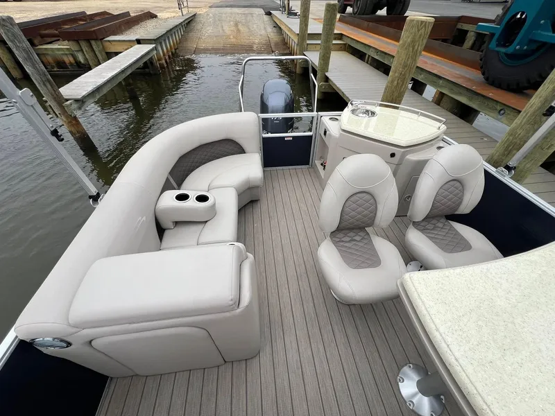 Slide: The Image of 2018 Bennington SX 23 pontoon boat interior with plush seating and modern design. - 5
