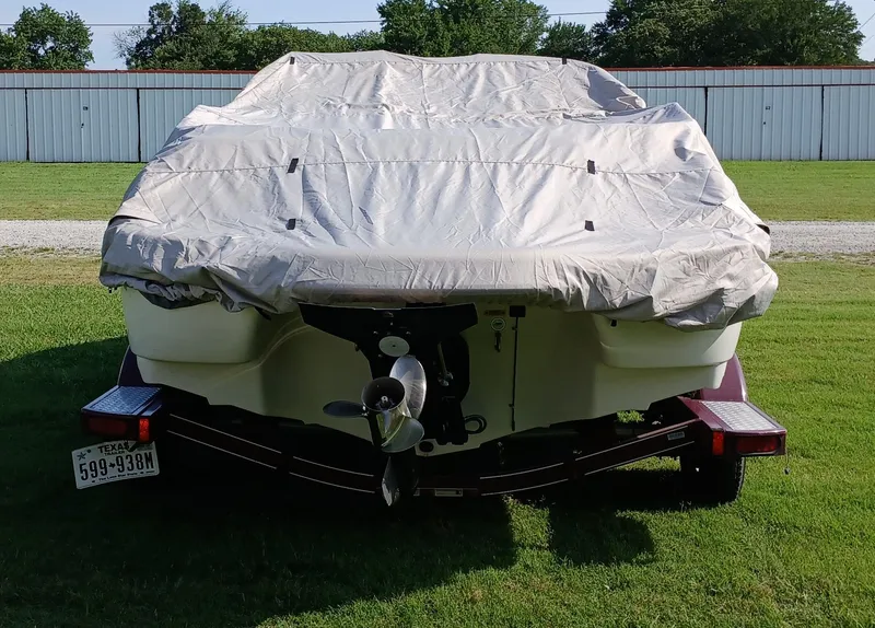 Slide: The Image of Covered 2008 Tahoe Q7i boat on trailer, parked on grass near storage facility. - 10
