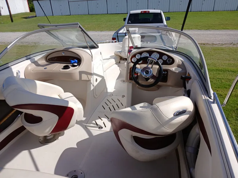 Slide: The Image of 2008 Tahoe Q7i boat interior with steering wheel, gauges, and seating. - 12
