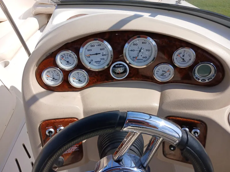 Slide: The Image of Dashboard of a 2008 Tahoe Q7i boat with gauges and steering wheel. - 18