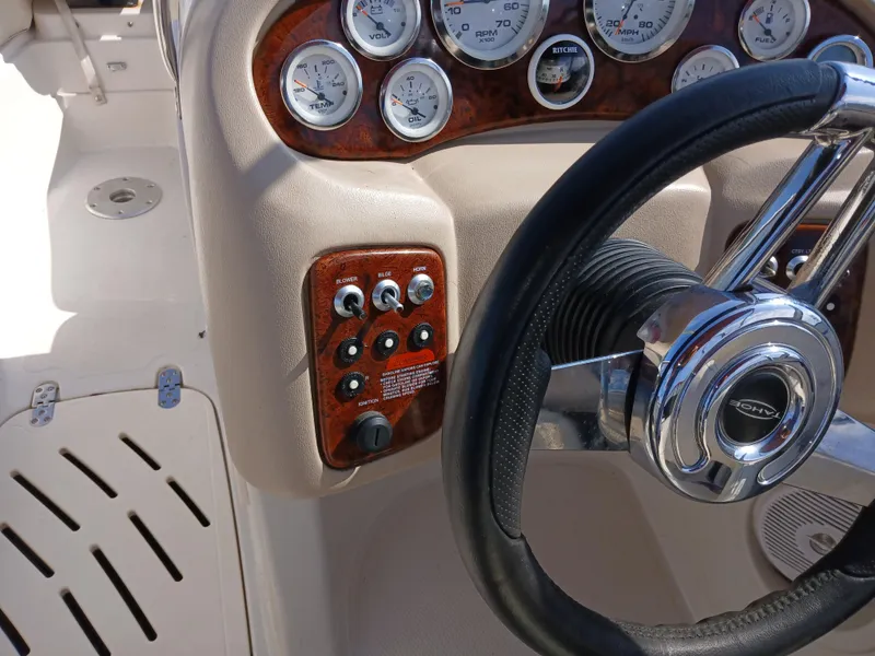 Slide: The Image of Steering wheel and dashboard controls of a 2008 Tahoe Q7i boat. - 19