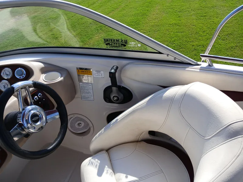 Slide: The Image of Interior of a 2008 Tahoe Q7i boat with steering wheel and white seating. - 22