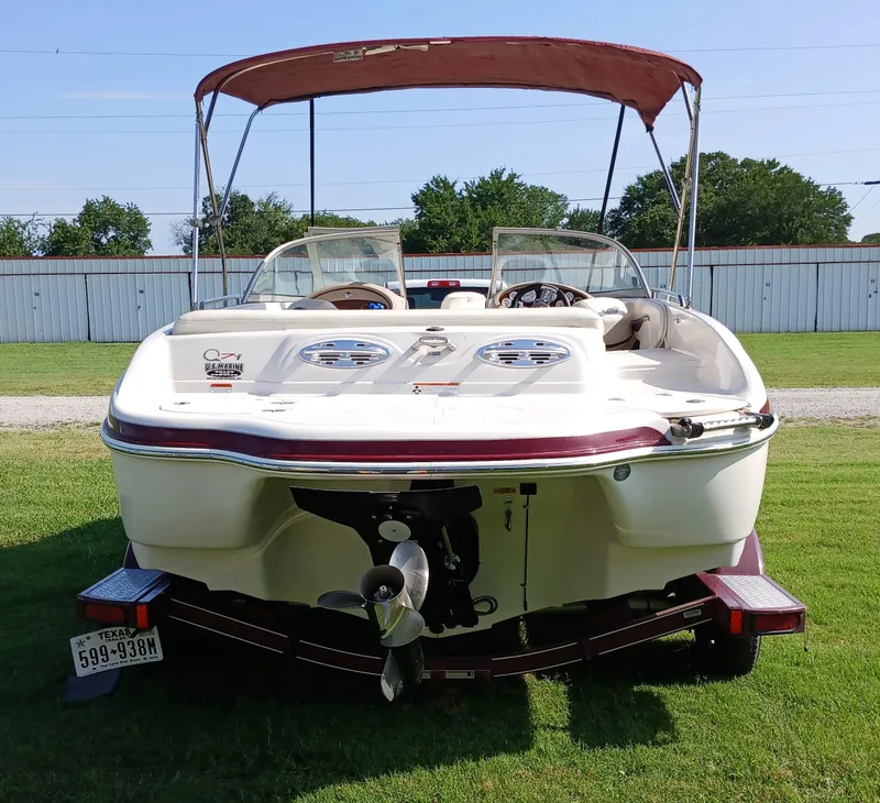 Slide: The Image of 2008 Tahoe Q7i boat on trailer, rear view, parked on grass. - 6