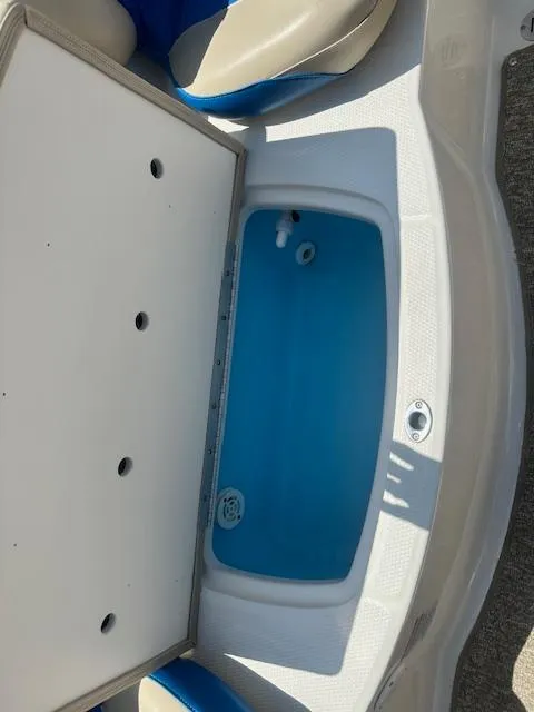 Slide: The Image of 2018 Chaparral 19 H2O Ski & Fish boat livewell, open with blue interior. - 20