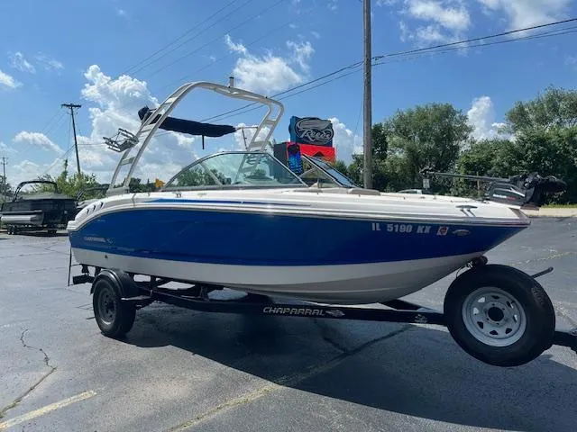 Slide: The Image of 2018 Chaparral 19 H2O Ski & Fish boat on trailer, blue and white, sunny day. - 3