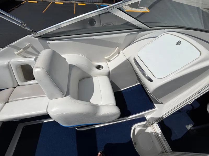 Slide: The Image of 1996 Chris-Craft 25 Concept boat interior with white seating and blue carpet. - 13
