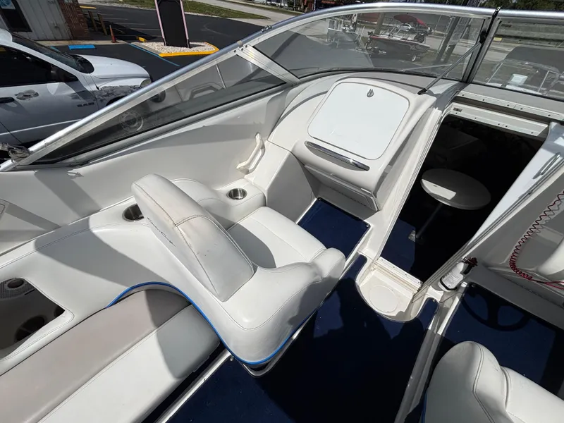 Slide: The Image of 1996 Chris-Craft 25 Concept boat interior with white seating and blue carpet. - 17