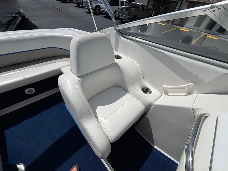 Slide: The Image of 1996 Chris-Craft 25 Concept boat interior with white seating and blue carpet. - 19