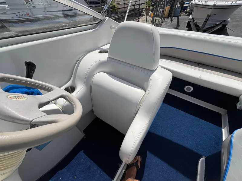 Slide: The Image of 1996 Chris-Craft 25 Concept boat interior with white seating and blue carpet. - 21
