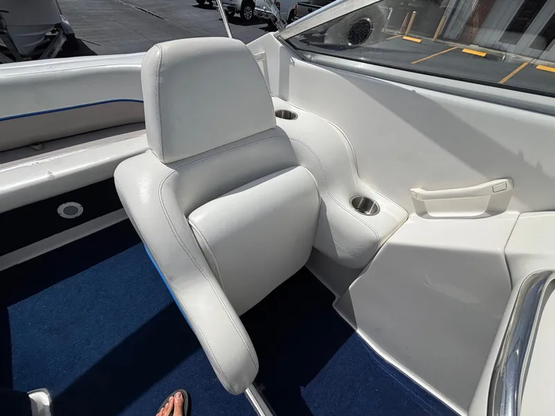 Slide: The Image of 1996 Chris-Craft 25 Concept boat interior with white seating and blue carpet. - 22
