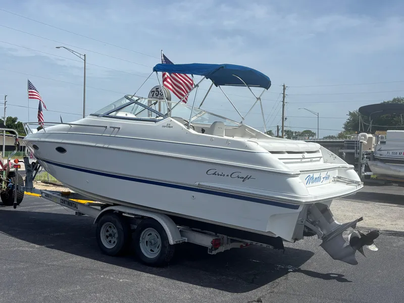 Slide: The Image of 1996 Chris-Craft 25 Concept boat on trailer with American flags in background. - 4