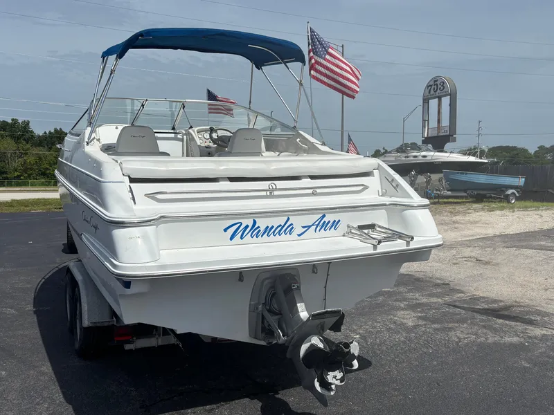 Slide: The Image of 1996 Chris-Craft 25 Concept boat with blue canopy and American flags, named "Wanda Ann." - 6