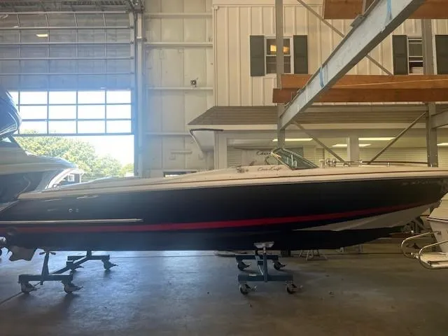 Slide: The Image of 2004 Chris-Craft Corsair 25 boat in indoor storage facility. - 0