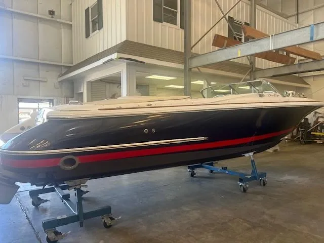 Slide: The Image of 2004 Chris-Craft Corsair 25 boat in indoor storage facility. - 1