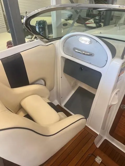 Slide: The Image of 2004 Chris-Craft Corsair 25 interior with beige seating and wooden flooring. - 11