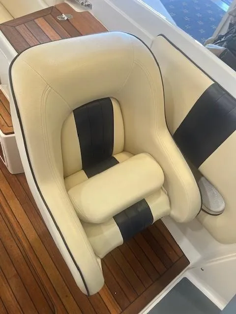 Slide: The Image of Luxurious seat on 2004 Chris-Craft Corsair 25 boat, featuring cream and black upholstery. - 14