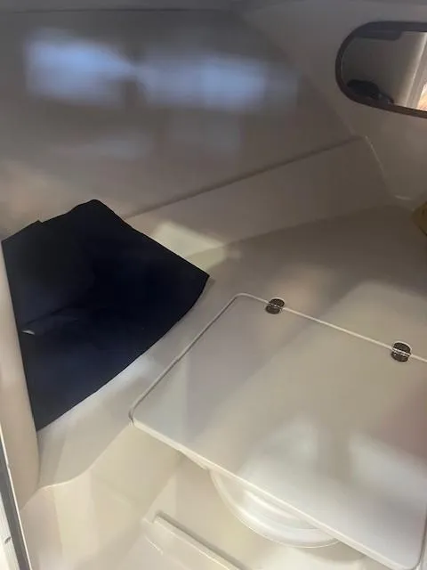 Slide: The Image of 2004 Chris-Craft Corsair 25 cabin interior with seating and storage. - 20