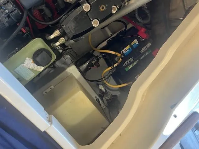 Slide: The Image of Engine compartment of a 2004 Chris-Craft Corsair 25 boat, showing battery and components. - 22