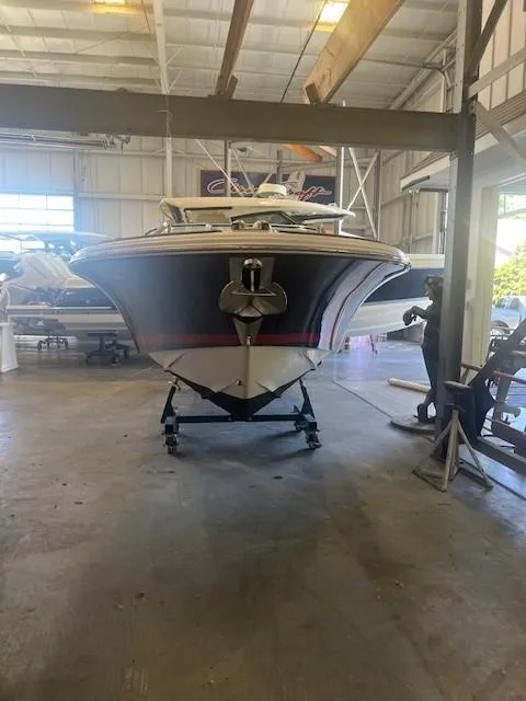 Slide: The Image of 2004 Chris-Craft Corsair 25 boat in a warehouse, front view. - 3