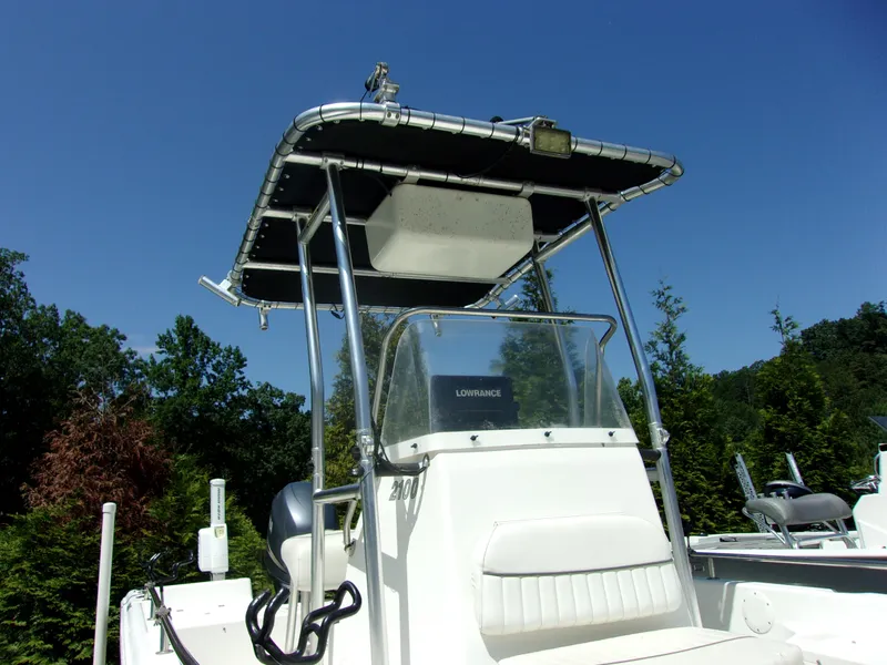 Slide: The Image of Tidewater 2100 Bay Max 2011 boat with T-top and console, set against a clear blue sky. - 12