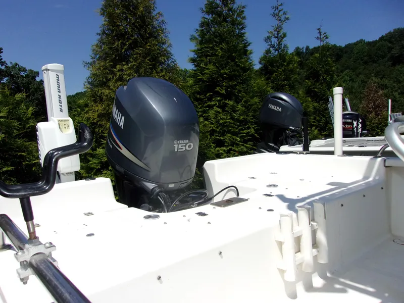 Slide: The Image of 2011 Tidewater 2100 Bay Max boat with Yamaha 150 engine, surrounded by lush greenery. - 14