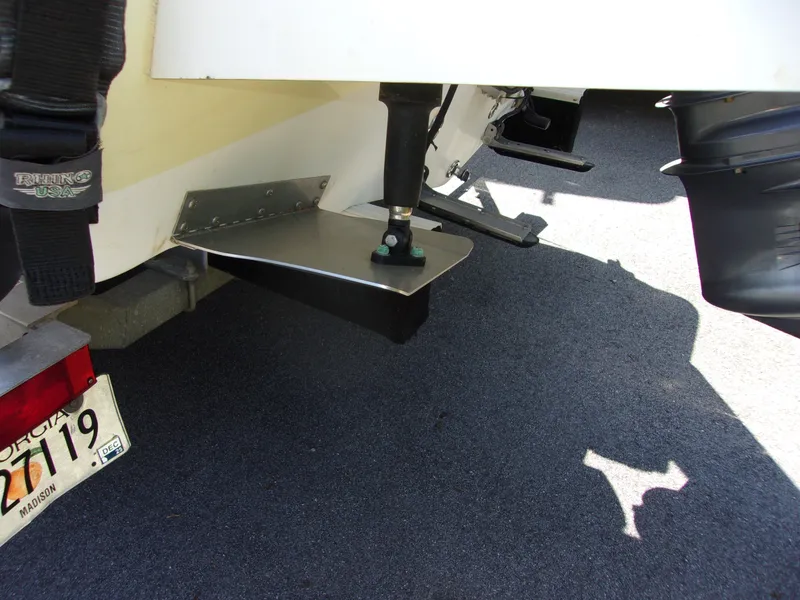 Slide: The Image of 2011 Tidewater 2100 Bay Max boat with trim tab and outboard motor detail. - 16