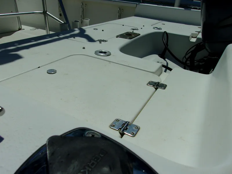 Slide: The Image of 2011 Tidewater 2100 Bay Max boat deck with storage compartments and hardware. - 6