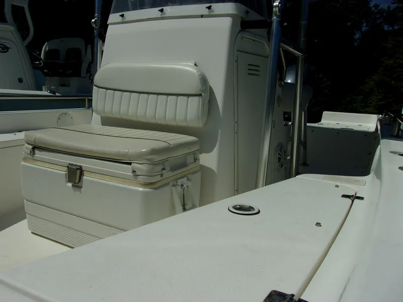 Slide: The Image of 2011 Tidewater 2100 Bay Max boat interior with cushioned seating and storage. - 9
