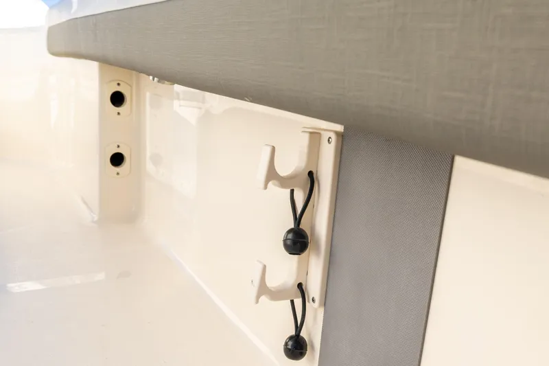 Slide: The Image of 2026 Scout 281 X Signature Edition boat interior detail with rod holders and sleek design. - 11