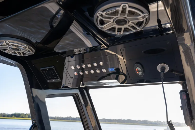Slide: The Image of 2026 Scout 281 X Signature Edition boat dashboard with speakers and control panel. - 15